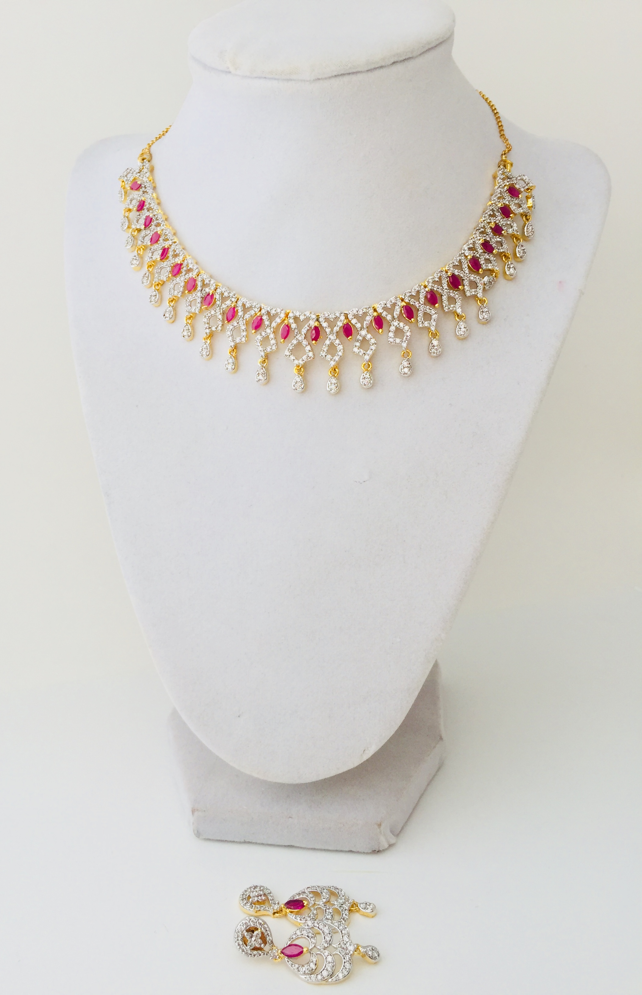 gold necklace with white stone designs